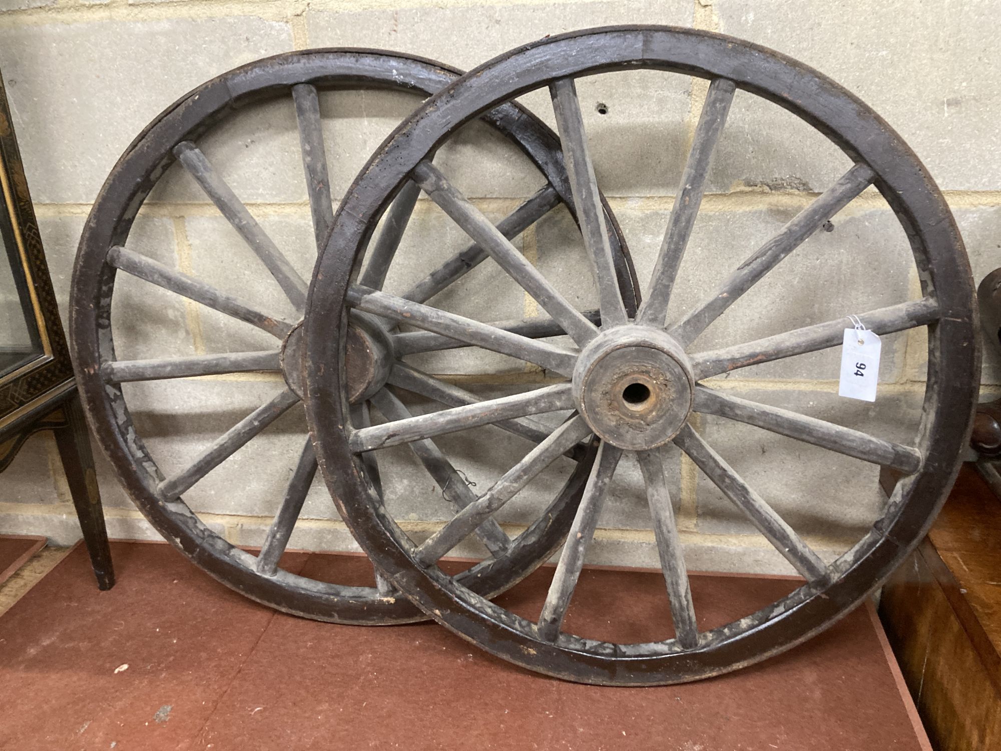 A pair of Victorian iron mounted spoked cart wheels, 70cm diameter